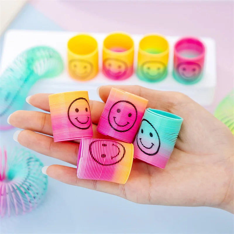 12Pcs Mini Smiley Face Rainbow Neon Magic Spring Toys